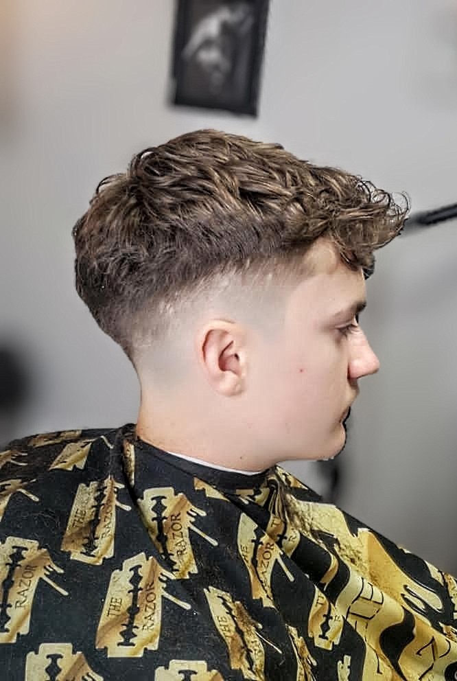 Man with a textured crop hairstyle, showcasing effortless style and versatility in Toronto.