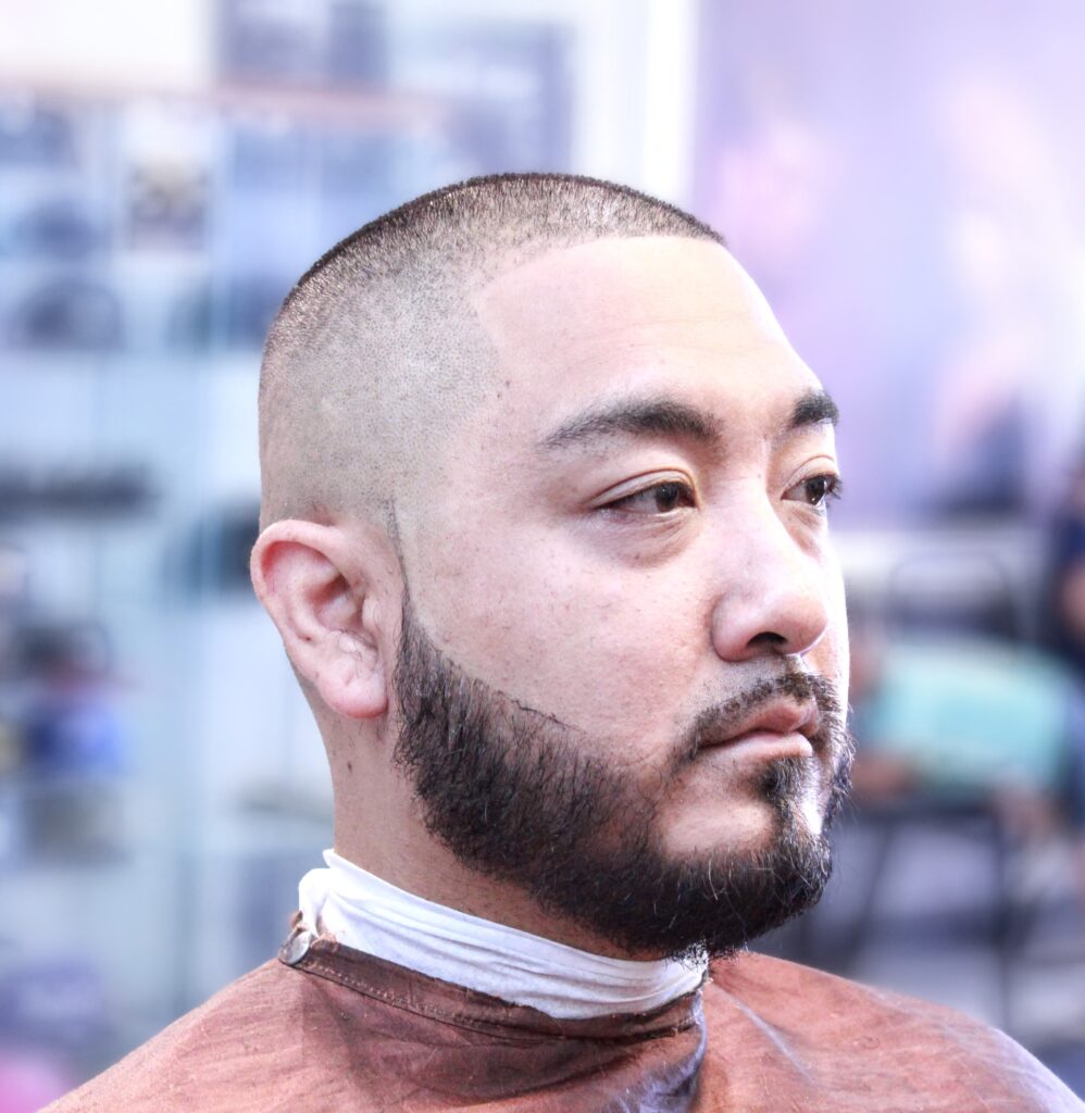 Man with a buzz cut featuring a fade, demonstrating low maintenance and modern appeal in Ontario.